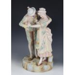 An Austrian bisque figure of a courting couple, early 20th century, gilt highlighted, 42cm high (