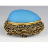 A mid-19th century French etui, modelled as a blue glass egg upon a gilt metal nest raised on four