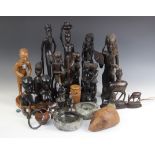 A collection of East African hardwood tribal carvings, to include a warrior figure modelled in a