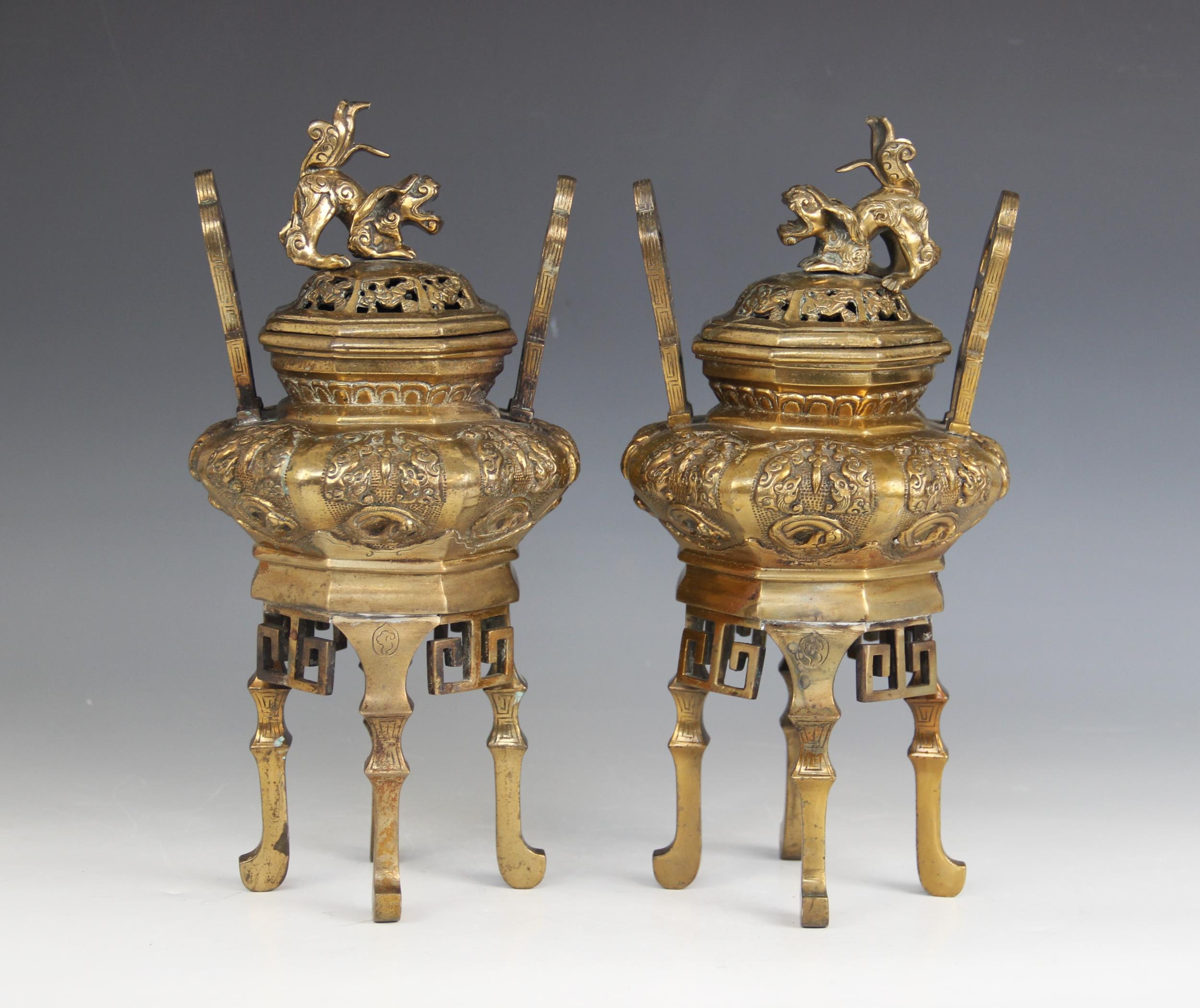 A pair of Chinese incense burners and covers, late 19th century, each of archaic form with relief