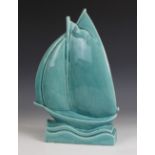 An Art Deco model of a sailing boat by Lejan, turquoise craquele glaze, modelled on a stylized
