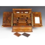 A Victorian figured walnut stationery slope, the twin doors opening to a removable perpetual desk