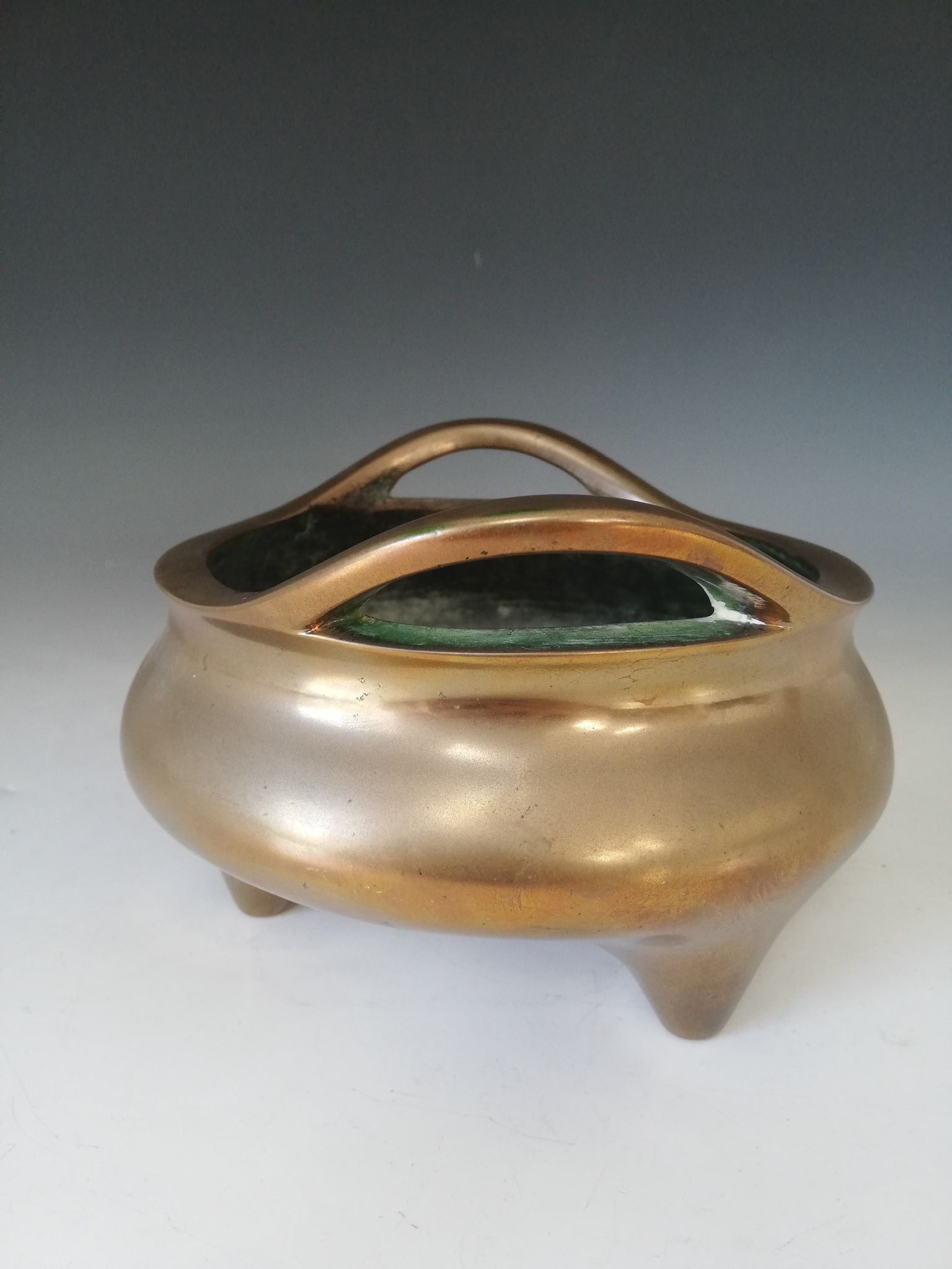 A Chinese polished bronze censer, Xuande mark, of typical plain circular form raised on three legs - Image 8 of 15