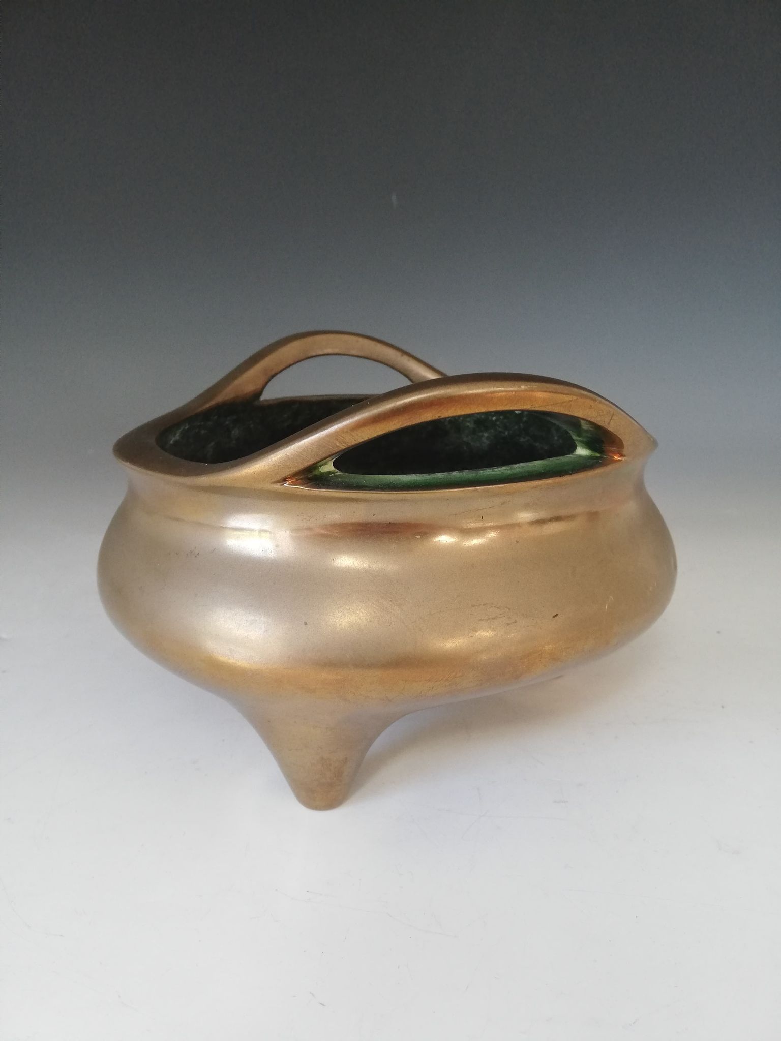 A Chinese polished bronze censer, Xuande mark, of typical plain circular form raised on three legs - Image 13 of 15