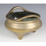A Chinese polished bronze censer, Xuande mark, of typical plain circular form raised on three legs