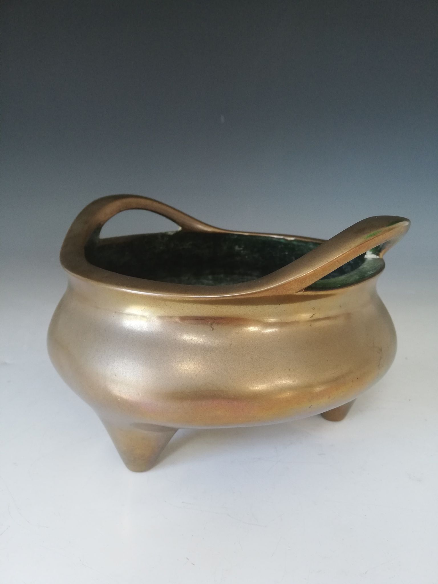 A Chinese polished bronze censer, Xuande mark, of typical plain circular form raised on three legs - Image 9 of 15