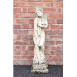 A reconstituted stone garden statue, modelled as a classical scantily clad female upon an integrated