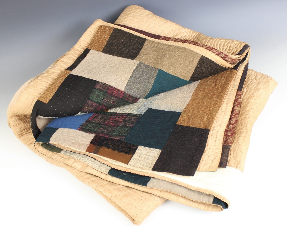 A wool patchwork quilt, late 19th century, made from tailor's scraps in browns, blues, pinks and