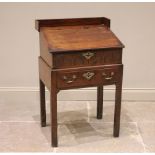 An 18th century oak bible box on stand, the galleried top above a crossbanded and hinged slope