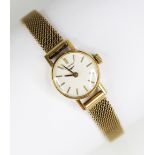 A ladies vintage 18ct gold Longines wristwatch, the circular white dial with baton markers, plain