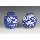 A pair of Chinese porcelain blue and white prunus pattern ginger jars and cover, 19th/20th