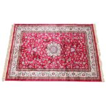 A full pile Kashmir carpet, the Shahbaz lozenge medallion upon a rich red ground, 240cm x 160cm