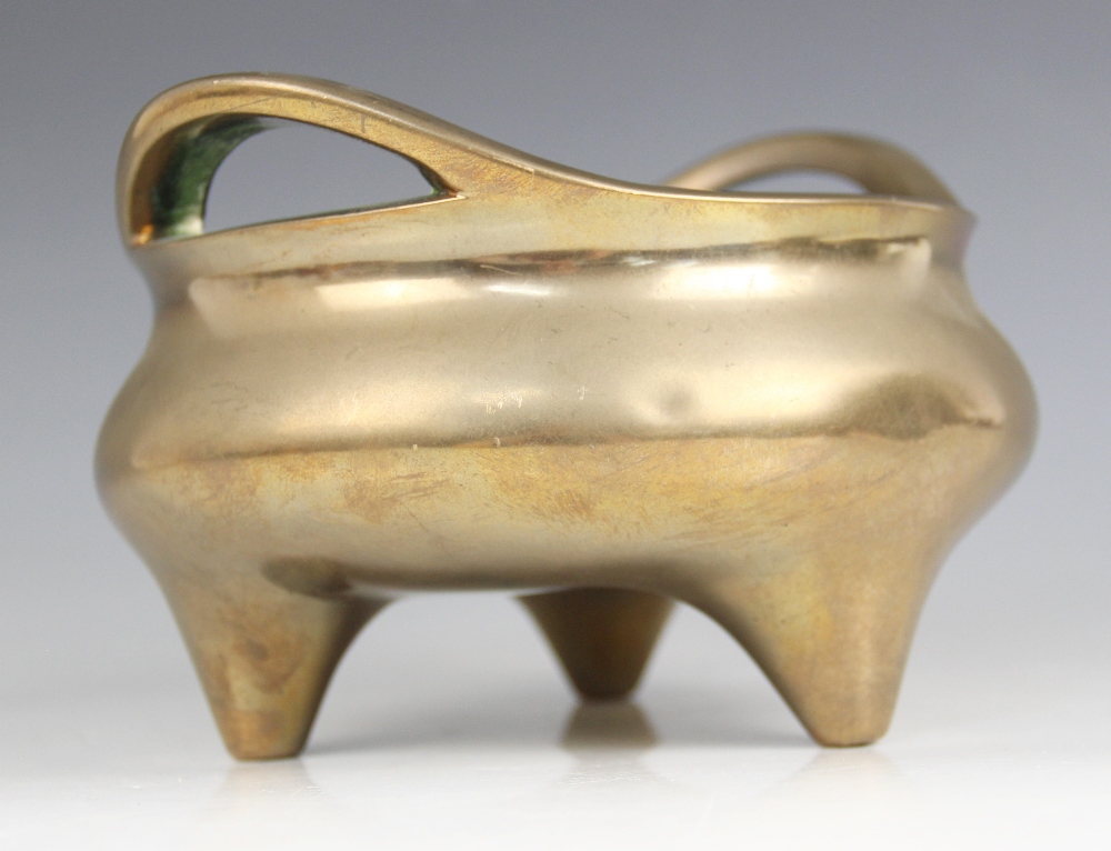 A Chinese polished bronze censer, Xuande mark, of typical plain circular form raised on three legs - Image 3 of 15