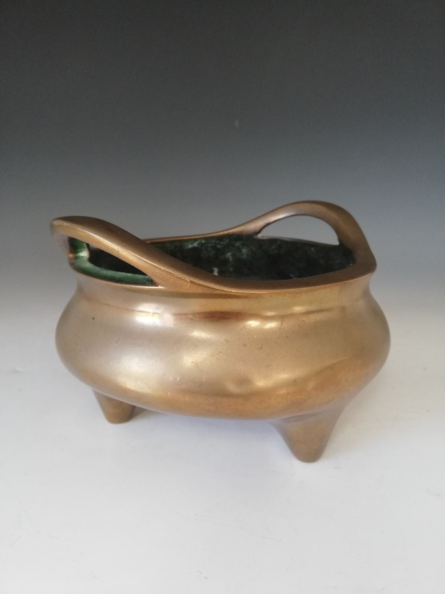 A Chinese polished bronze censer, Xuande mark, of typical plain circular form raised on three legs - Image 11 of 15