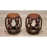 A pair of Chinese carved wood jardinière stands, 20th century, each of hollow barrel form with