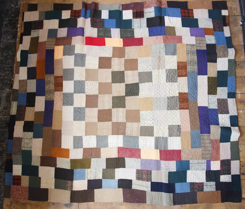 A wool patchwork quilt, late 19th century, made from tailor's scraps in browns, blues, pinks and - Image 2 of 6