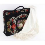 A Berlin work style needlepoint carpet bag, 20th century, the side panels decorated with floral