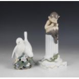A Royal Copenhagen model of lovebirds, model number 'Y02', 13.5cm high, with a model of a faun sat