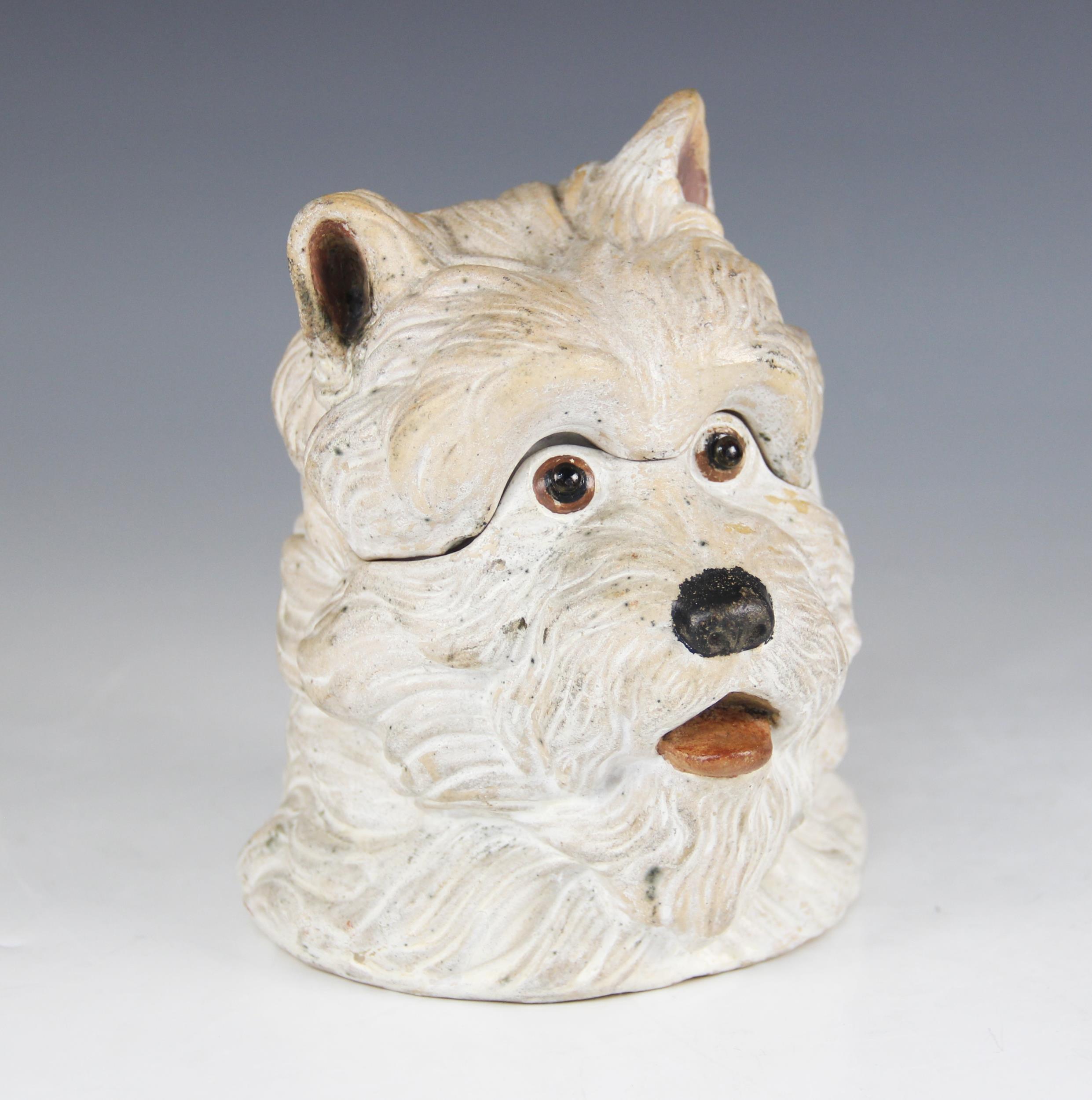 A novelty stoneware tobacco jar, 20th century, modelled as a Scottish Terrier, with removable cover,