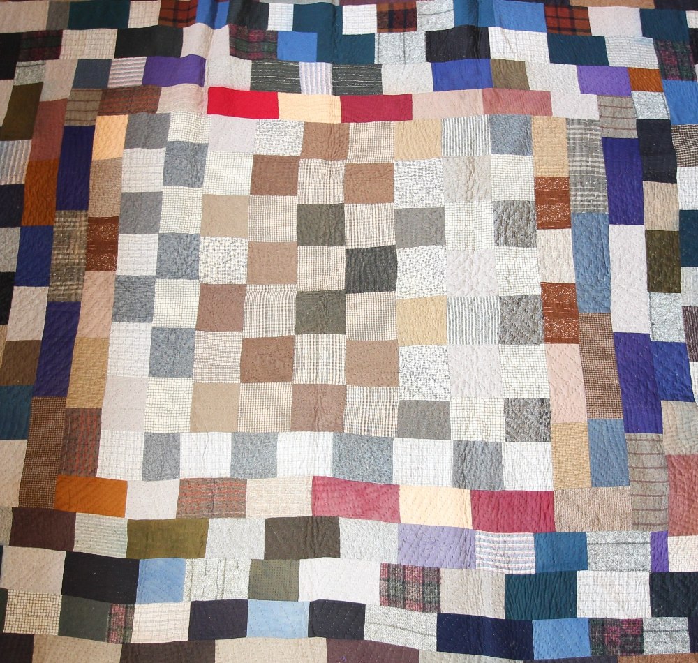 A wool patchwork quilt, late 19th century, made from tailor's scraps in browns, blues, pinks and - Image 4 of 6
