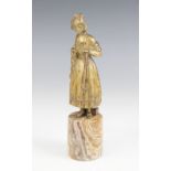 An Art Deco patinated bronze model of a girl, modelled standing holding a bouquet of flowers, upon a