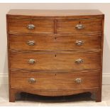 A late George III mahogany bow front chest of drawers, the crossbanded top inlaid with ebony