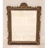 A gilt wood and gesso rococo style wall mirror, late 19th/early 20th century, the leaf swept frame