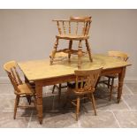 A Victorian style pine kitchen table, the rectangular plank top raised upon turned legs and peg