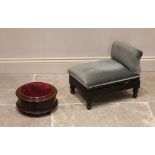 A Victorian mahogany footstool, of drum form with an upholstered hinged top opening to a vacant