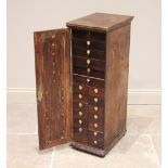 A George III mahogany haberdashery/collectors cabinet, the single door opening to an arrangement