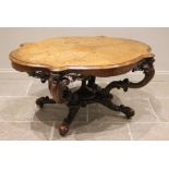 A Victorian burr walnut centre table, the quarter veneered serpentine moulded top raised upon four