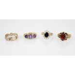 An amethyst and diamond ring, comprising three oval mixed cut amethysts, central amethyst