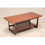 A McIntosh teak coffee table, the rectangular moulded top raised upon quadrangle supports united