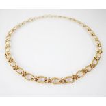 A 9ct gold graduated fancy-link necklace, comprising alternating oval rope twist links and plain