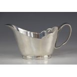A silver sauce boat, Mappin & Webb, Sheffield 1966, of tapering oval form with shaped border and