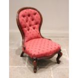 A Victorian mahogany framed balloon back nursing chair, later re-covered in red foliate fabric,