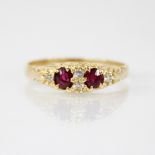 A Victorian ruby and diamond ring, comprising two oval mixed cut rubies, each measuring 4.2mm x 3.