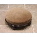 A Victorian mahogany framed upholstered circular footstool, the sprung seat above a channelled