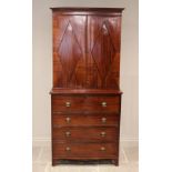 A late George III mahogany secretaire bookcase, the moulded cornice over a pair of segmentally