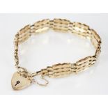 A 9ct gold gate link bracelet, the fancy brick links with engine turned detail, 19cm long, with