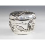 A Chinese silver coloured box and cover, of tapering circular form, embossed and engraved with koi