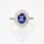 A tanzanite and diamond 18ct gold ring, the central oval mixed cut tanzanite measuring 8mm x 6mm,