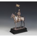 A silver coloured model of a 17th lancer of the Royal Light Brigade, modelled on horseback, all upon