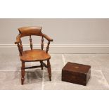 A Victorian child's ash and beech captains chair, with turned baluster spindles above a shaped seat,