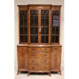 A George IV style mahogany breakfront bookcase, late 20th century, the moulded cornice above four