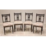 A set of four Victorian Aesthetic Movement chairs, each with a spindled gallery over an open work