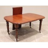 A Victorian mahogany dining table, the rectangular top with rounded corners raised upon turned and