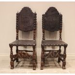A pair of 17th century and later walnut hall chairs, each with an arched and embossed leather back
