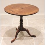 A George III mahogany tripod table, the circular top upon a birdcage mechanism and an annulated