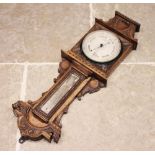 A Victorian carved oak wall barometer by Sewill, Liverpool, the case carved with 'C' scroll and